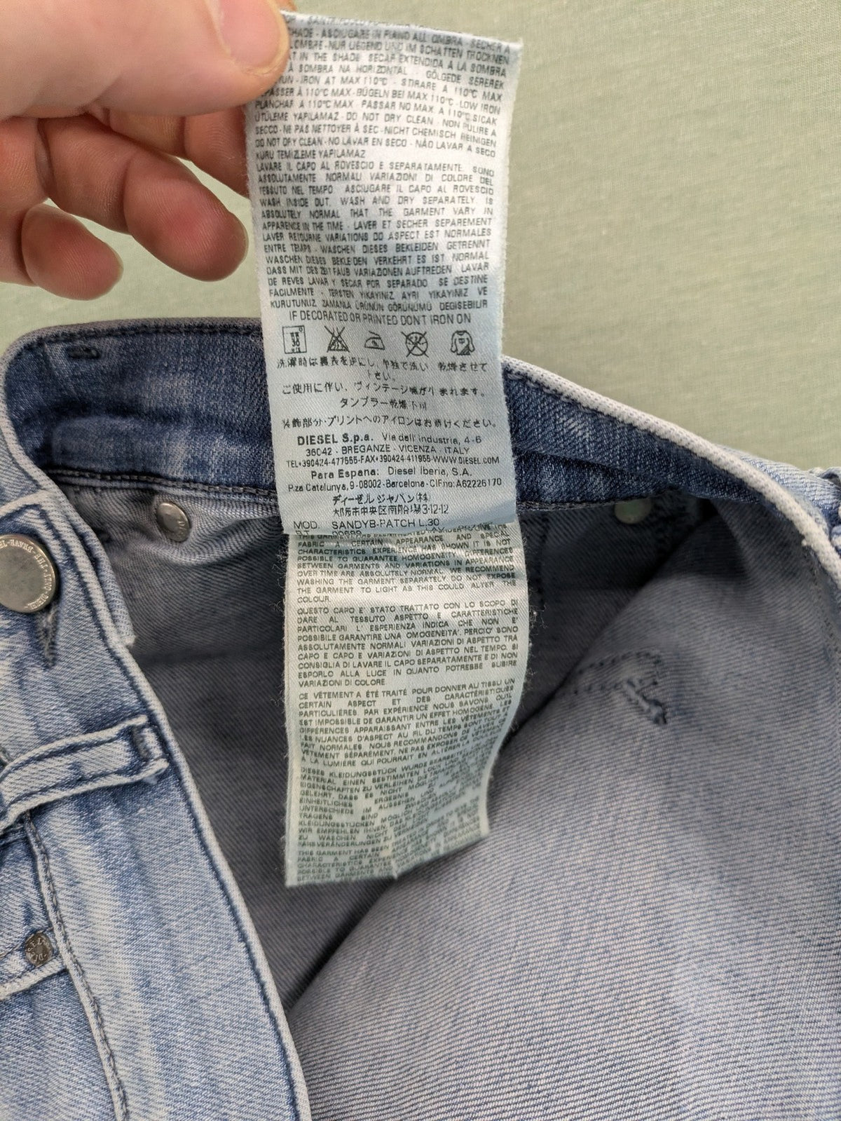 Diesel blue bootcut jeans with white patch pockets and regular waist, stylish stretch material.
