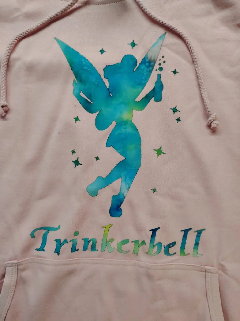 Just Hoods pink zip-through hoodie with "Trinkerbell" graphic, kangaroo pocket, drawstring hood.