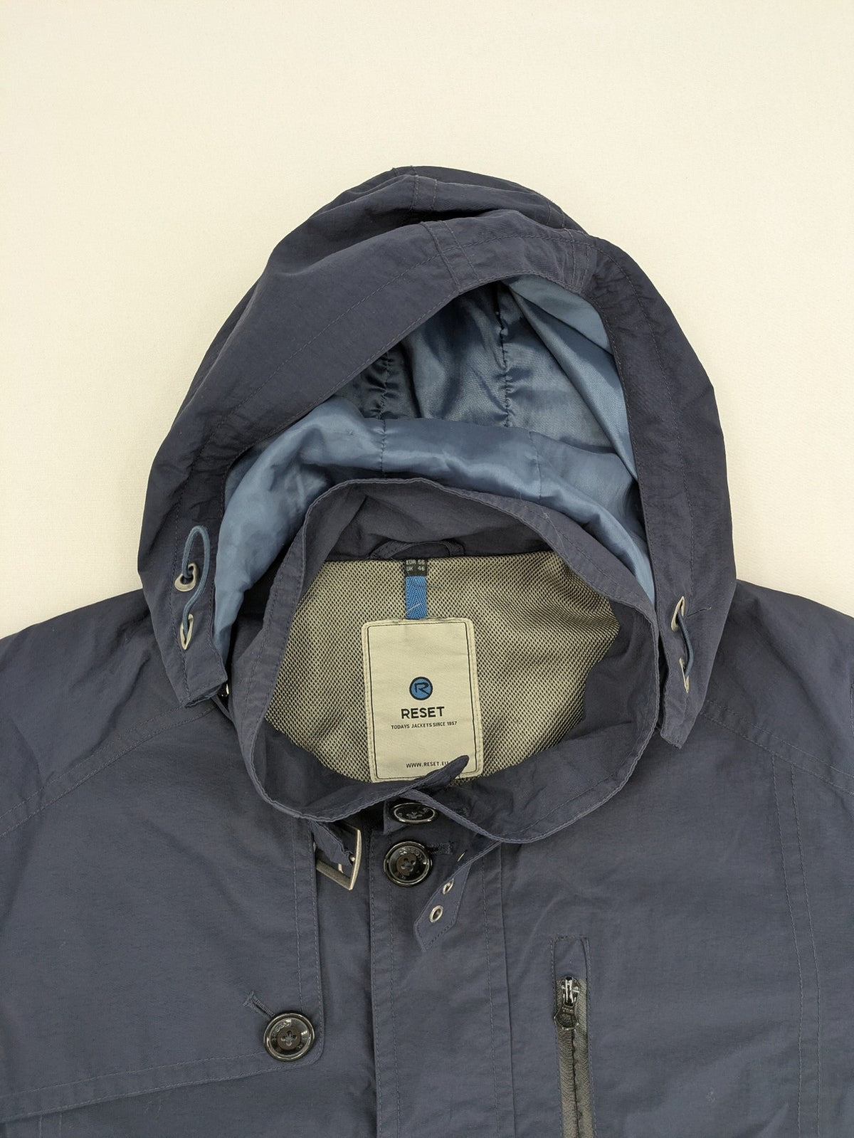 Reset navy parka jacket windproof with adjustable hood and zippered chest pocket.