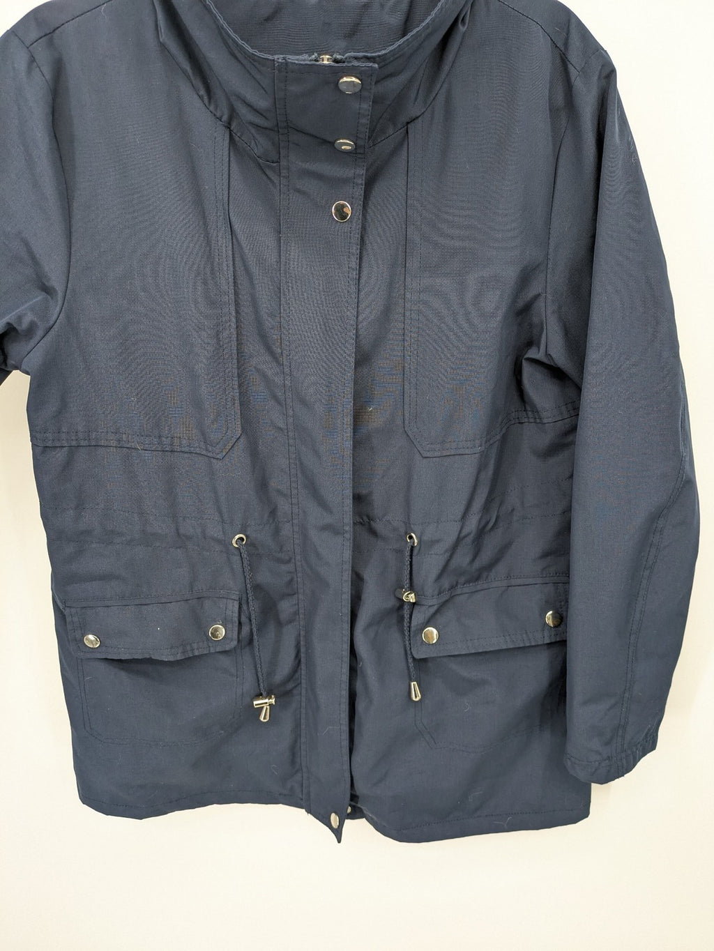 Janina navy anorak jacket with high collar and adjustable drawstring waist.