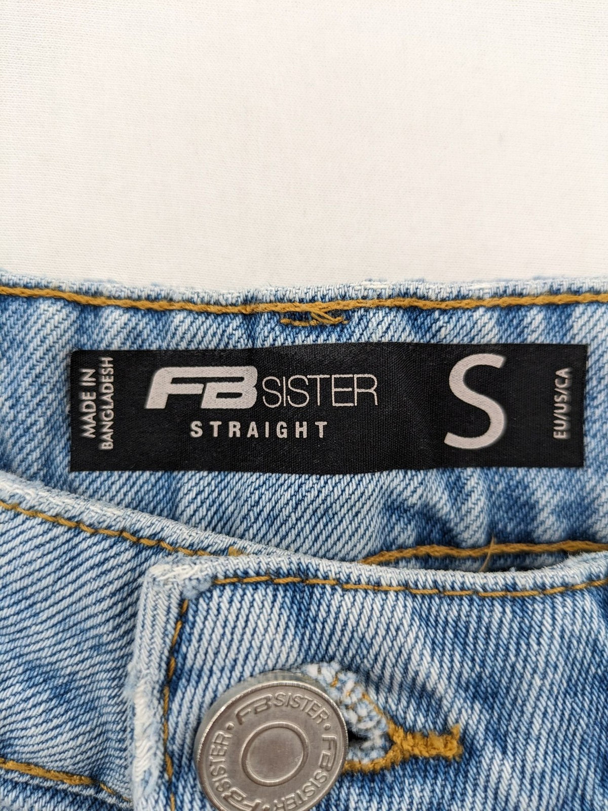 FB Sister blue straight leg jeans high rise with distressed detailing and button fly.