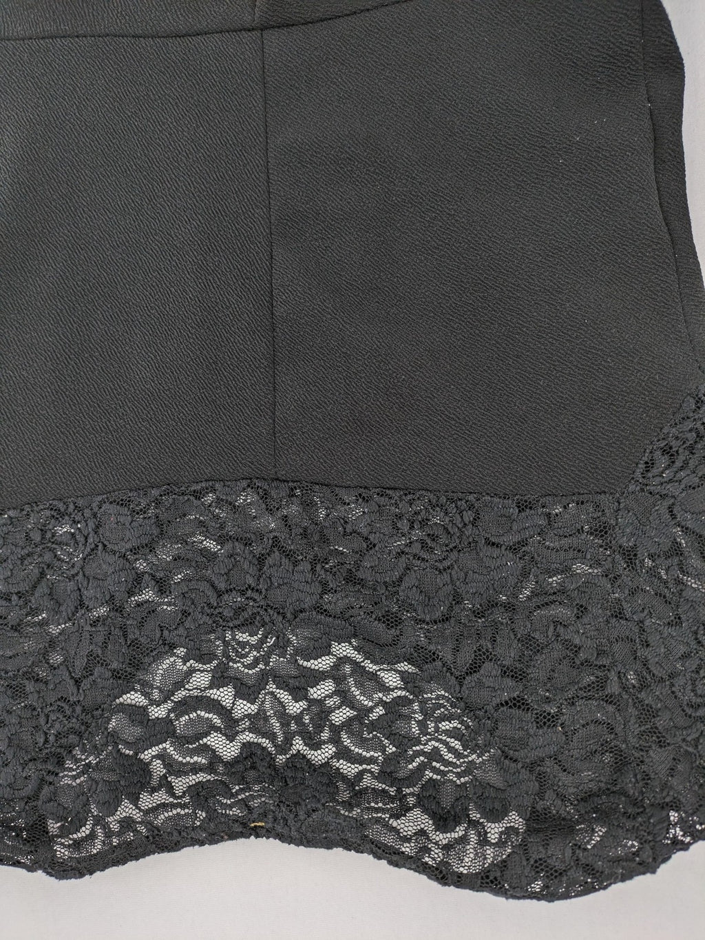 Amisu black peplum top with floral lace sleeves and delicate lace trim.