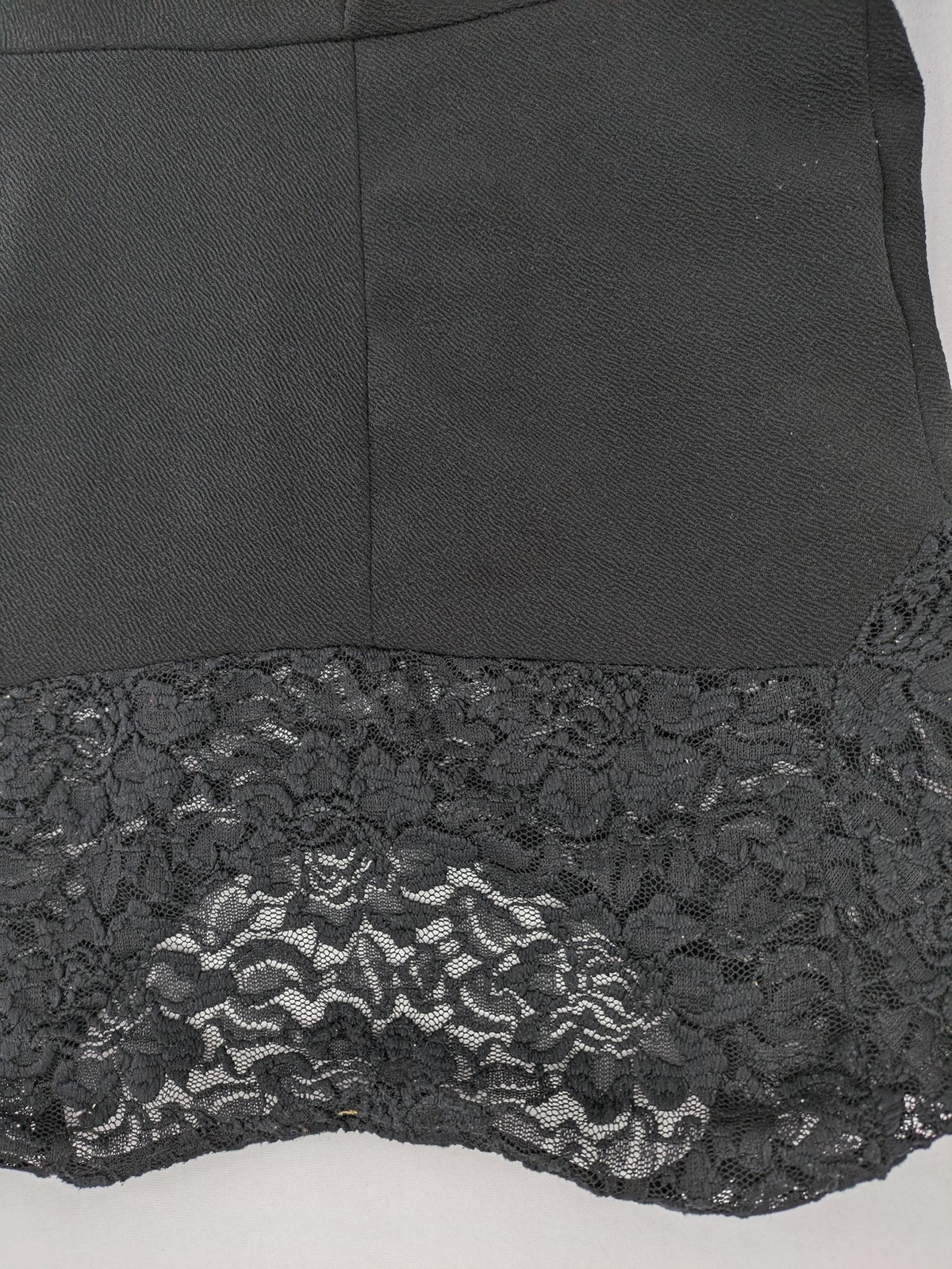 Amisu black peplum top with floral lace sleeves and delicate lace trim.