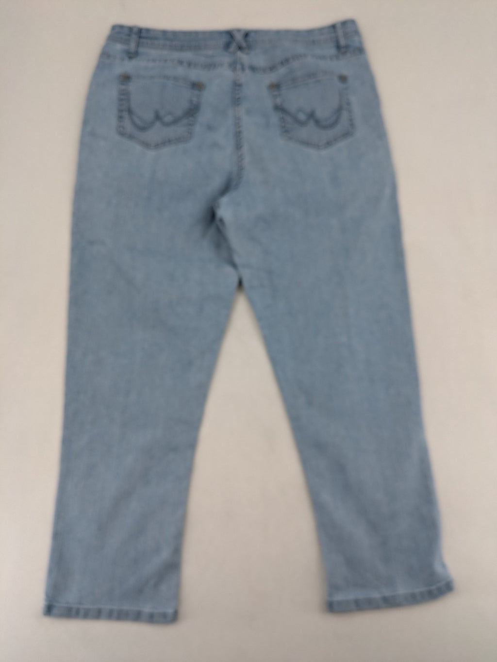 Capri blue straight jeans with 5-pocket design and embroidered details on back pockets.