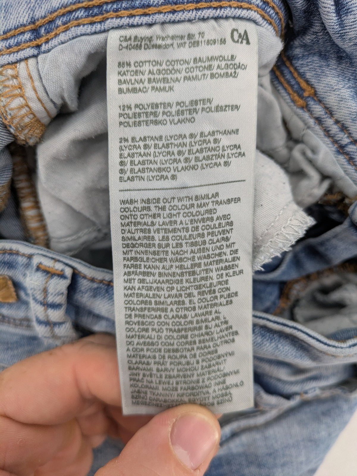 Clockhouse blue skinny jeans with distressed details and frayed hem, mid-rise fit.