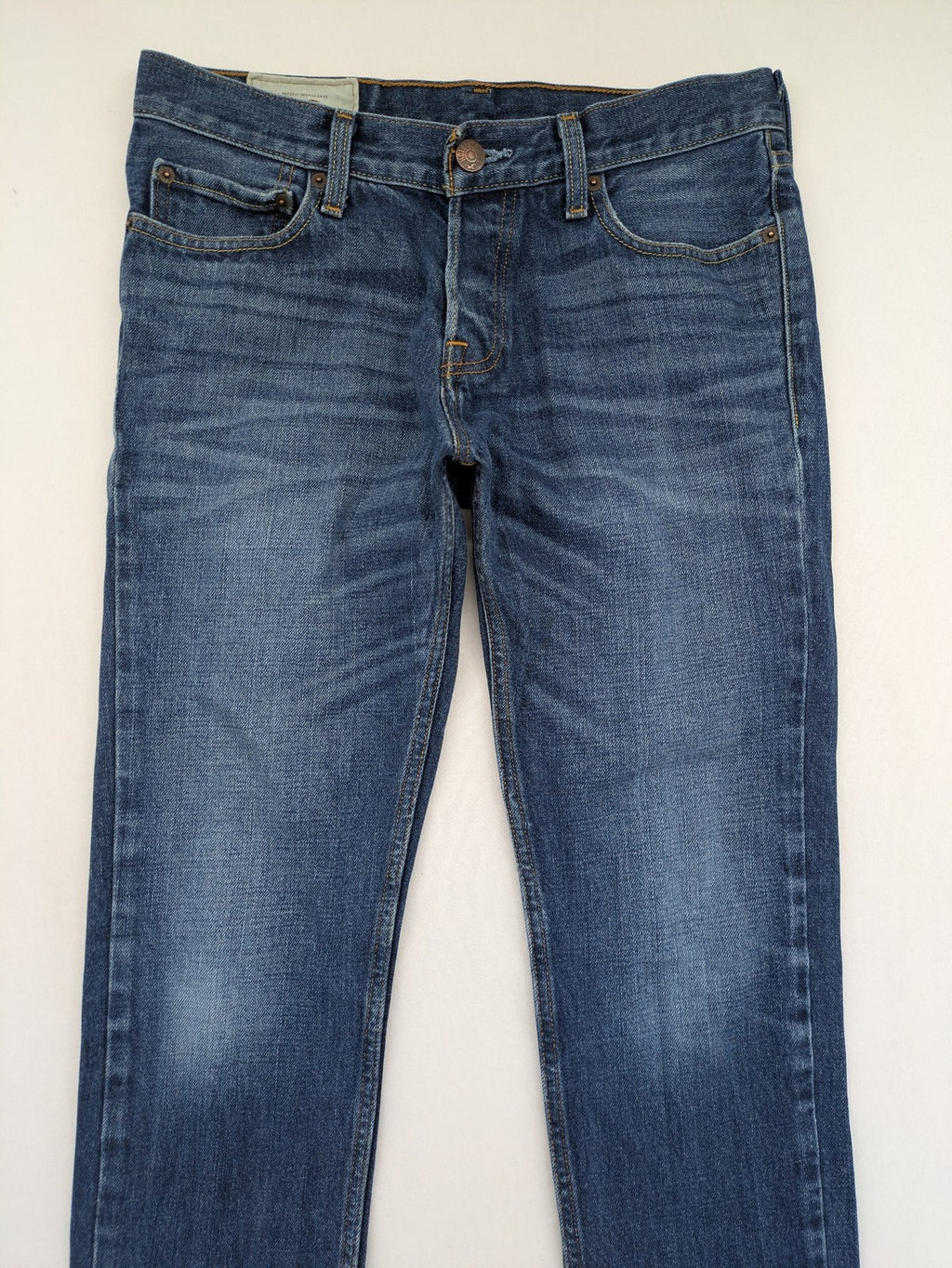 Hollister blue super skinny jeans medium wash button fly with faded details.