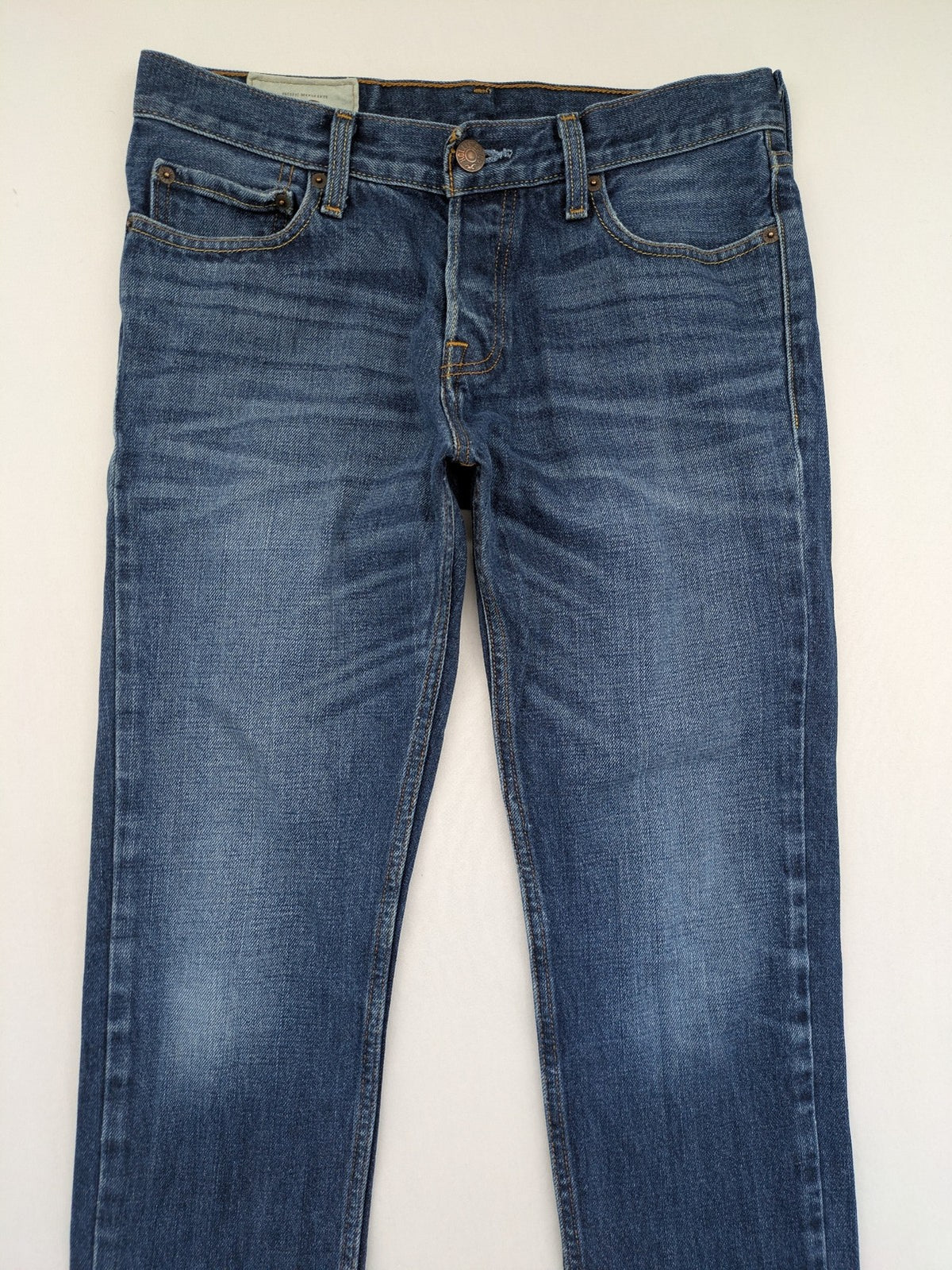 Hollister blue super skinny jeans medium wash button fly with faded details.