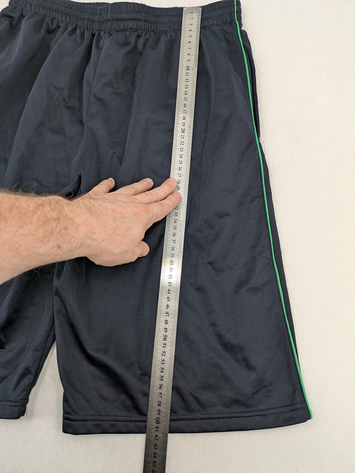 okay grey cargo shorts with green "ATHL. 5 DIVISION" graphic print and side pocket.
