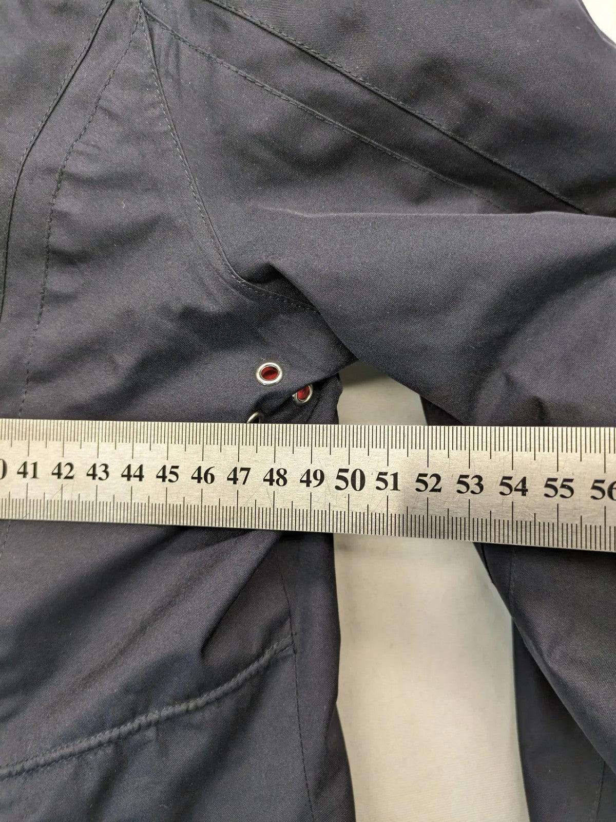 WPF grey outdoor jacket with red lining, zip closure, and hood.