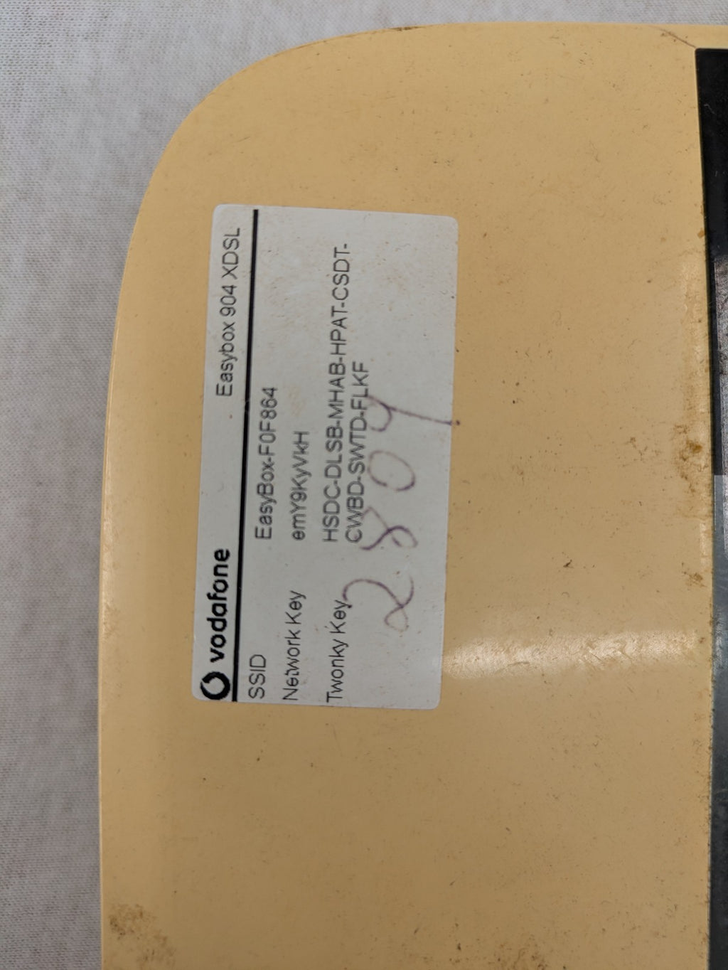 Vodafone wireless router beige and black with multiple LAN ports and USB connection.