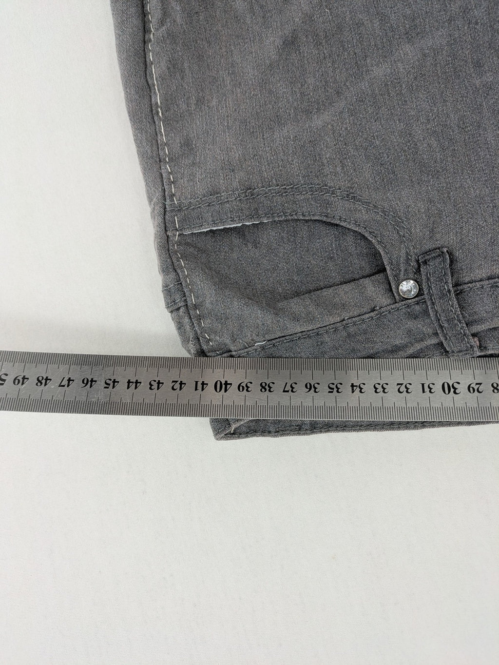 Jet Line grey straight jeans with embellished back pockets and frayed hem details.
