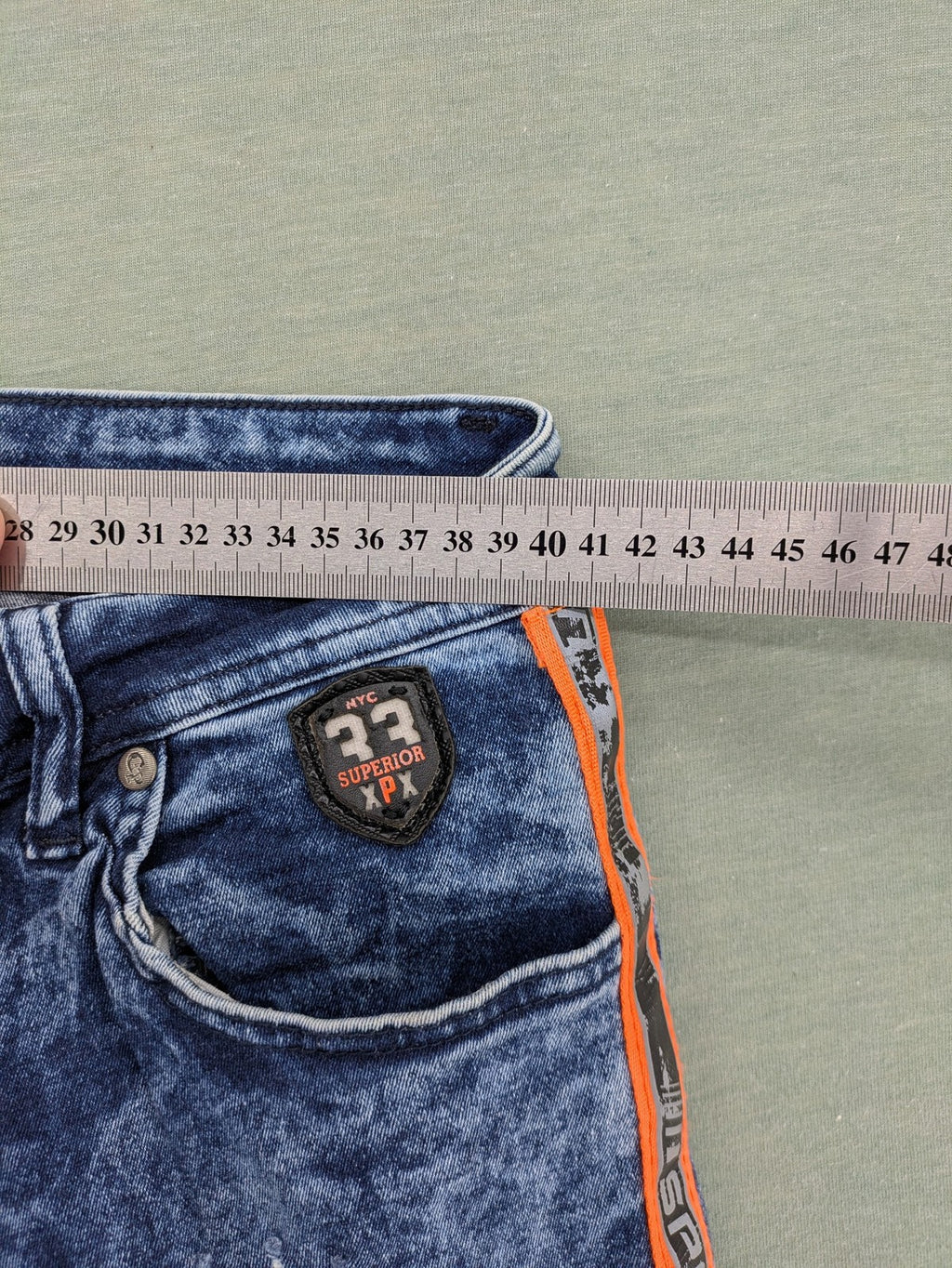 Stark straight jeans multi distressed acid wash with orange patches and side stripes.