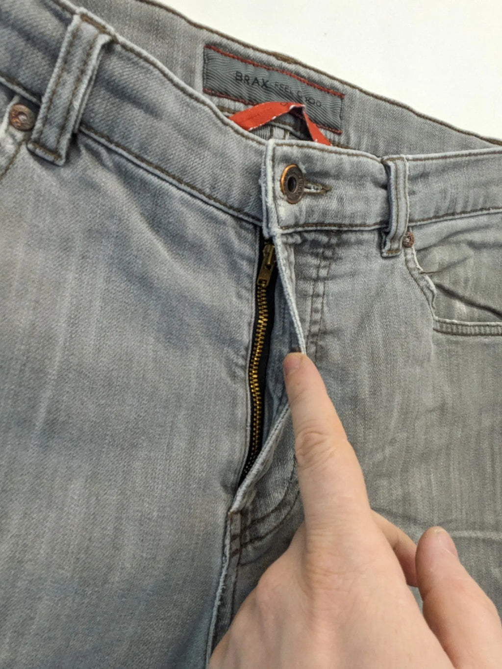 BRAX grey straight jeans with classic 5-pocket style and washed denim finish.