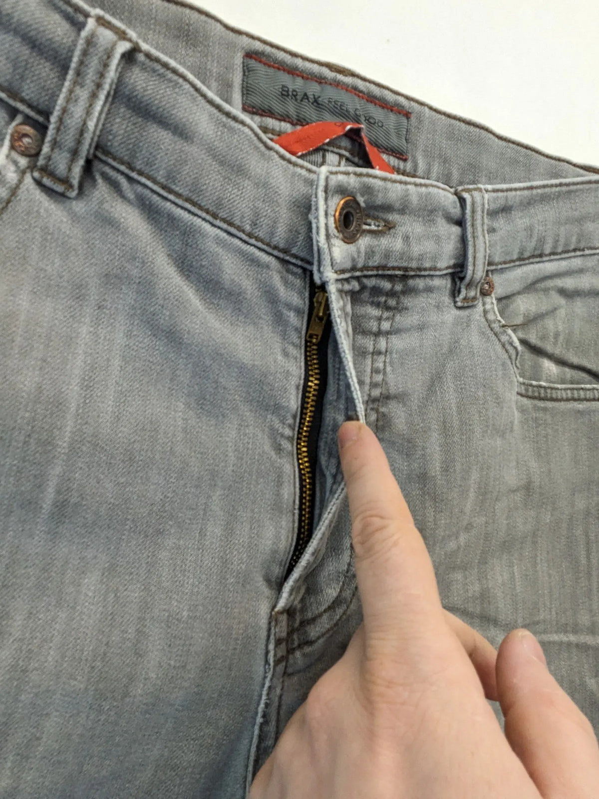 BRAX grey straight jeans with classic 5-pocket style and washed denim finish.