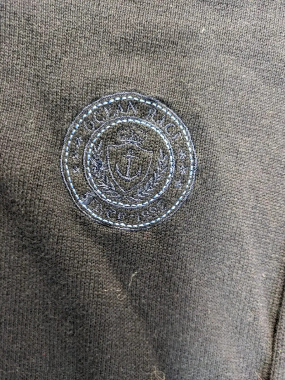 dunmore turtle neck jumper dark blue with striped trims and embroidered crest logo