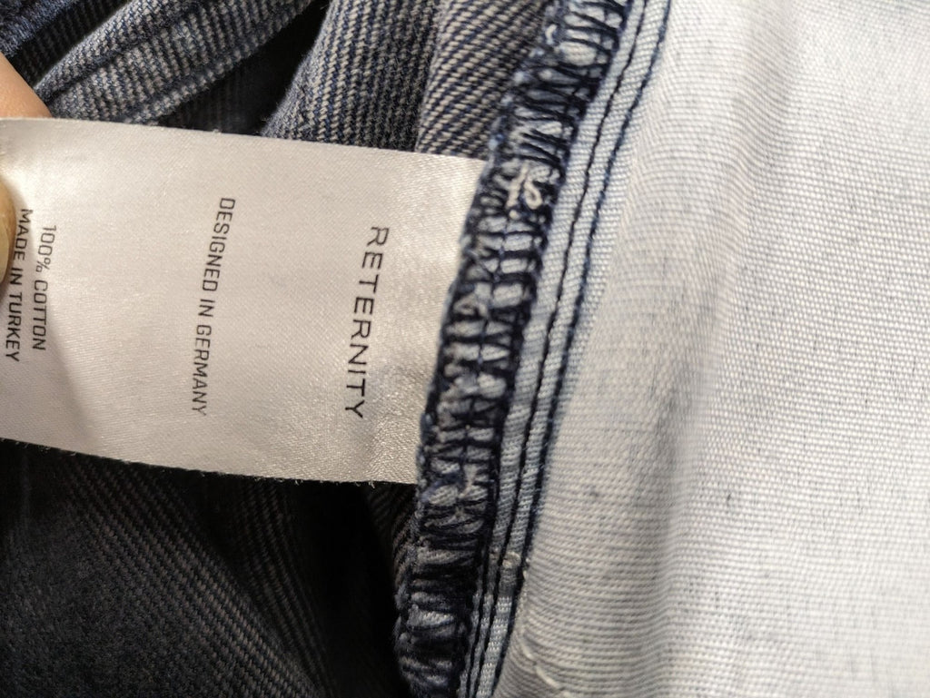 Reternity straight jeans blue black patchwork design with distressed details and frayed seams.