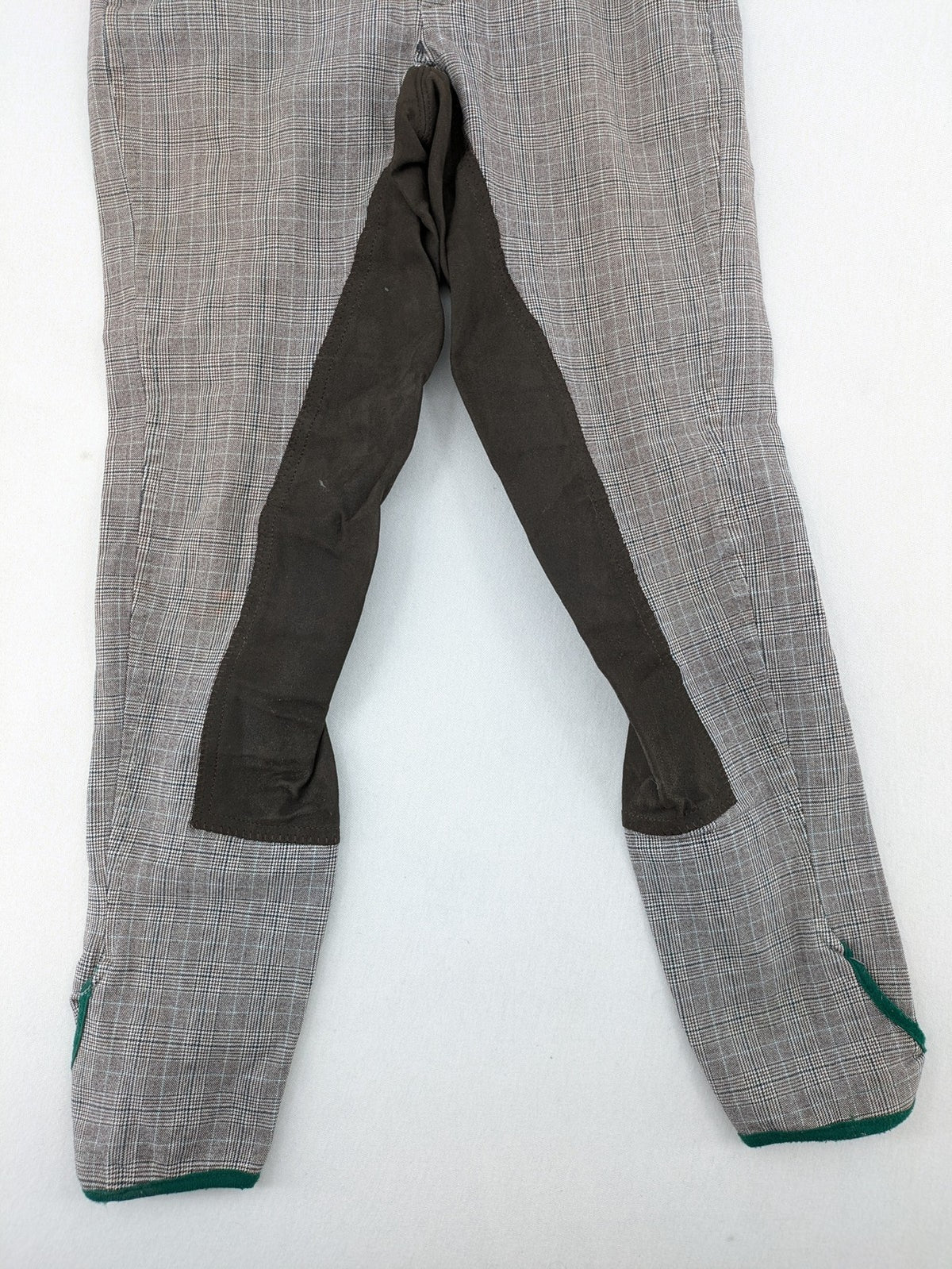 Cavallo grey check riding pants with brown full-seat patch and logo detail.
