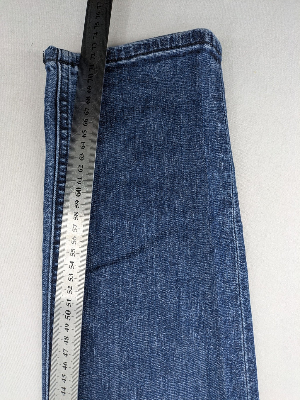 BOSS blue slim fit jeans with logo, five-pocket design, and button fly.