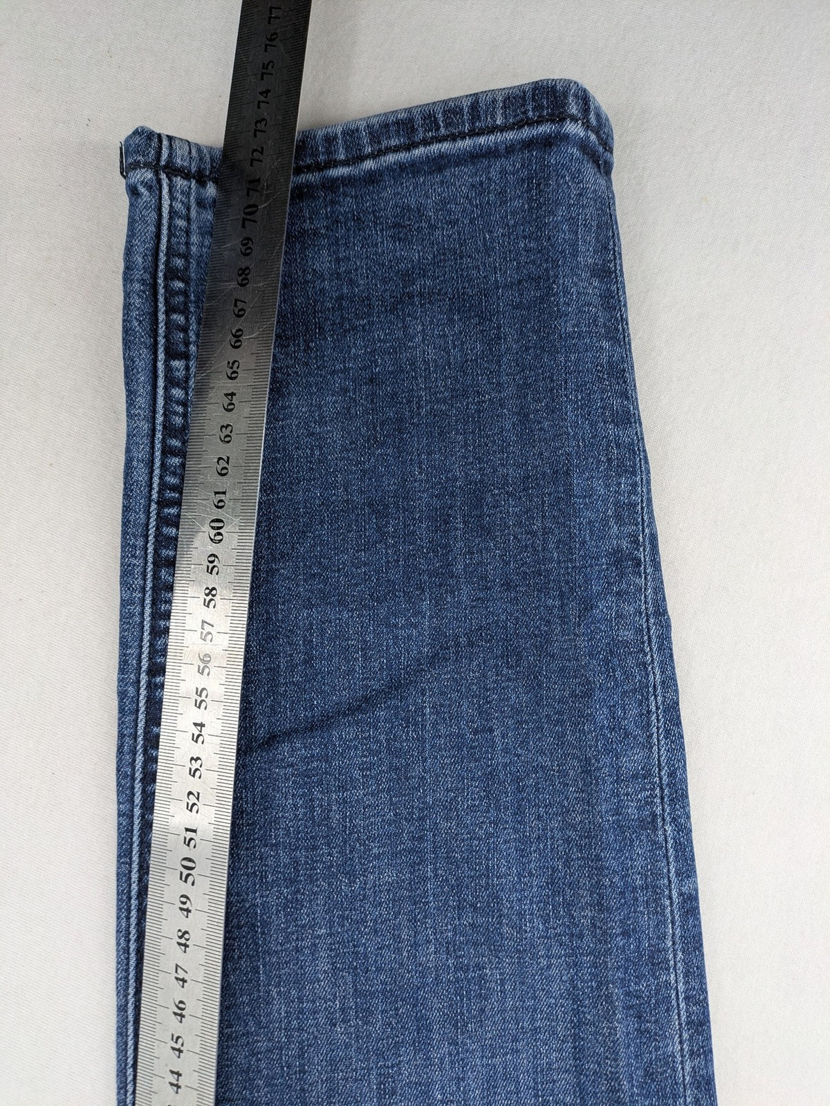 BOSS blue slim fit jeans with logo, five-pocket design, and button fly.