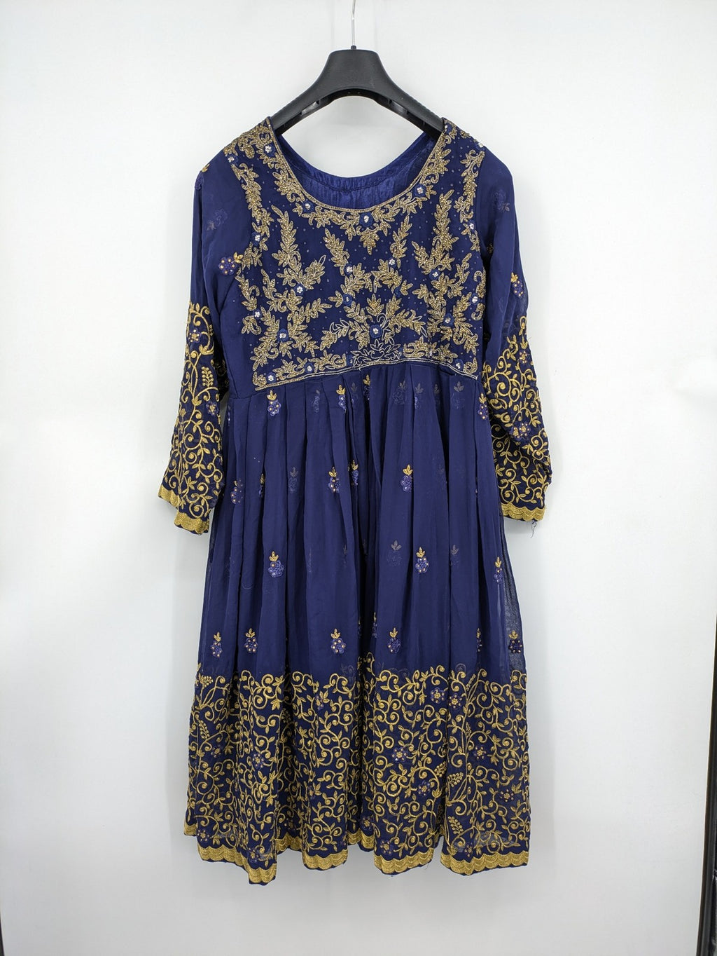 Bollywood bridal party dress gold with intricate blue embroidery and flowing Anarkali silhouette.