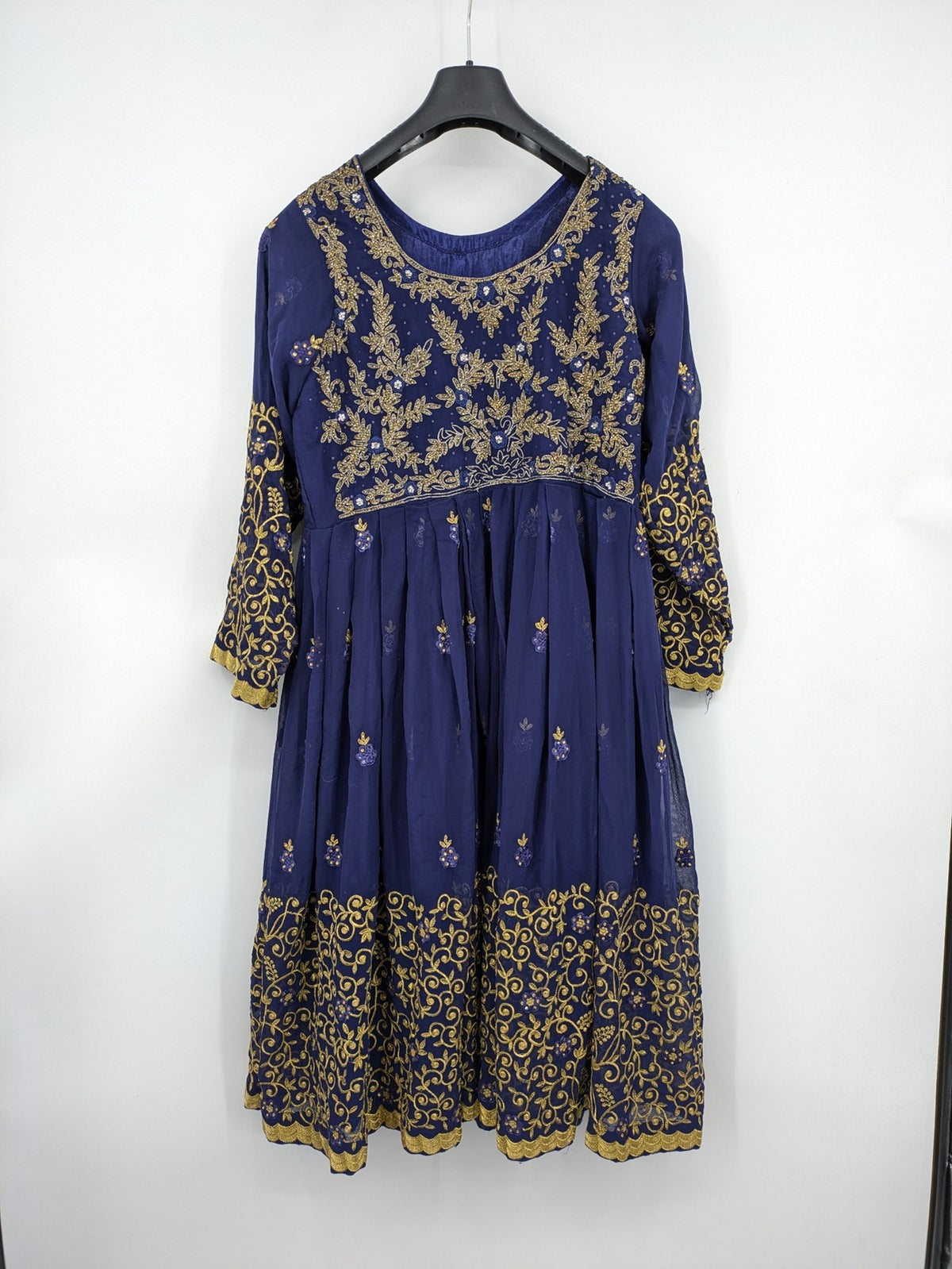 Bollywood bridal party dress gold with intricate blue embroidery and flowing Anarkali silhouette.