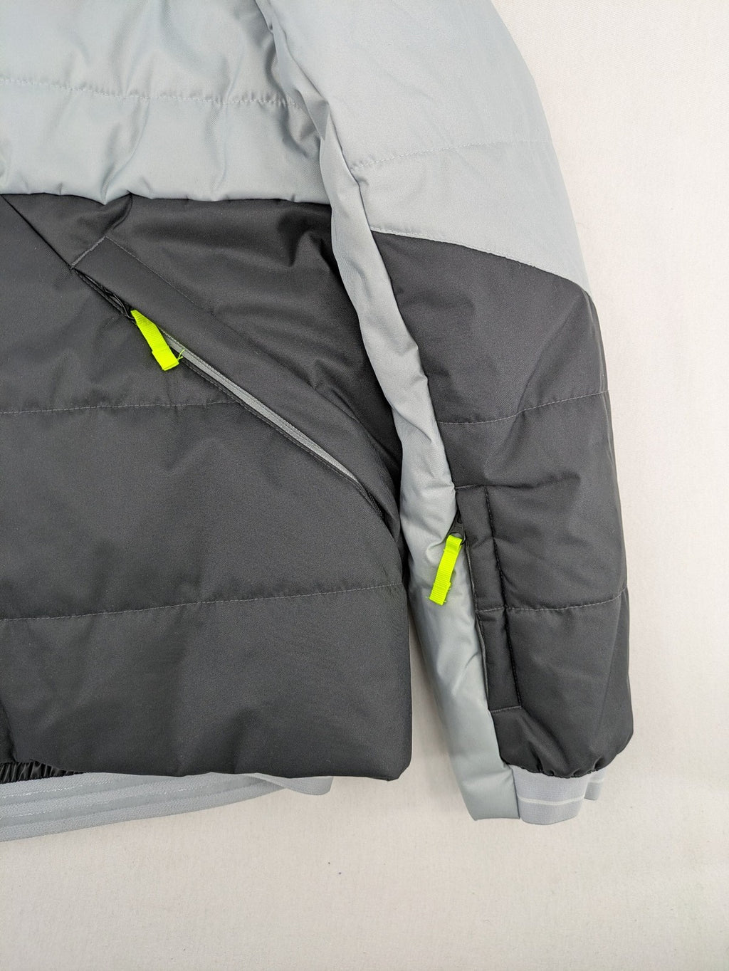 Wedze ski coat grey and black colorblock design with neon accents and fleece lining.