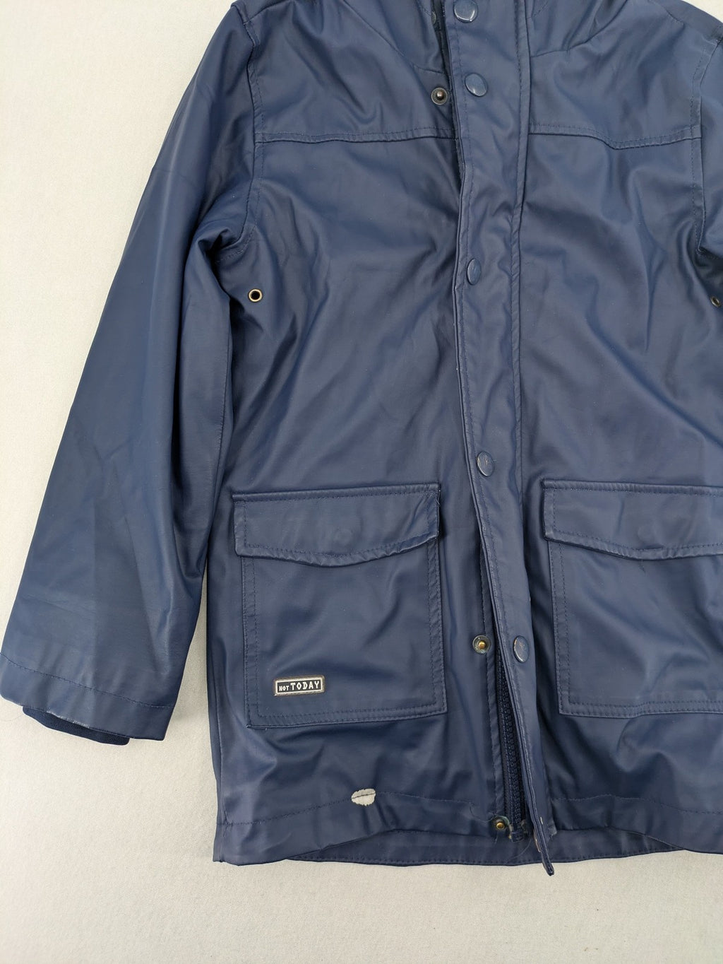 Pocopiano navy raincoat with striped lining and waterproof exterior, classic fisherman style.