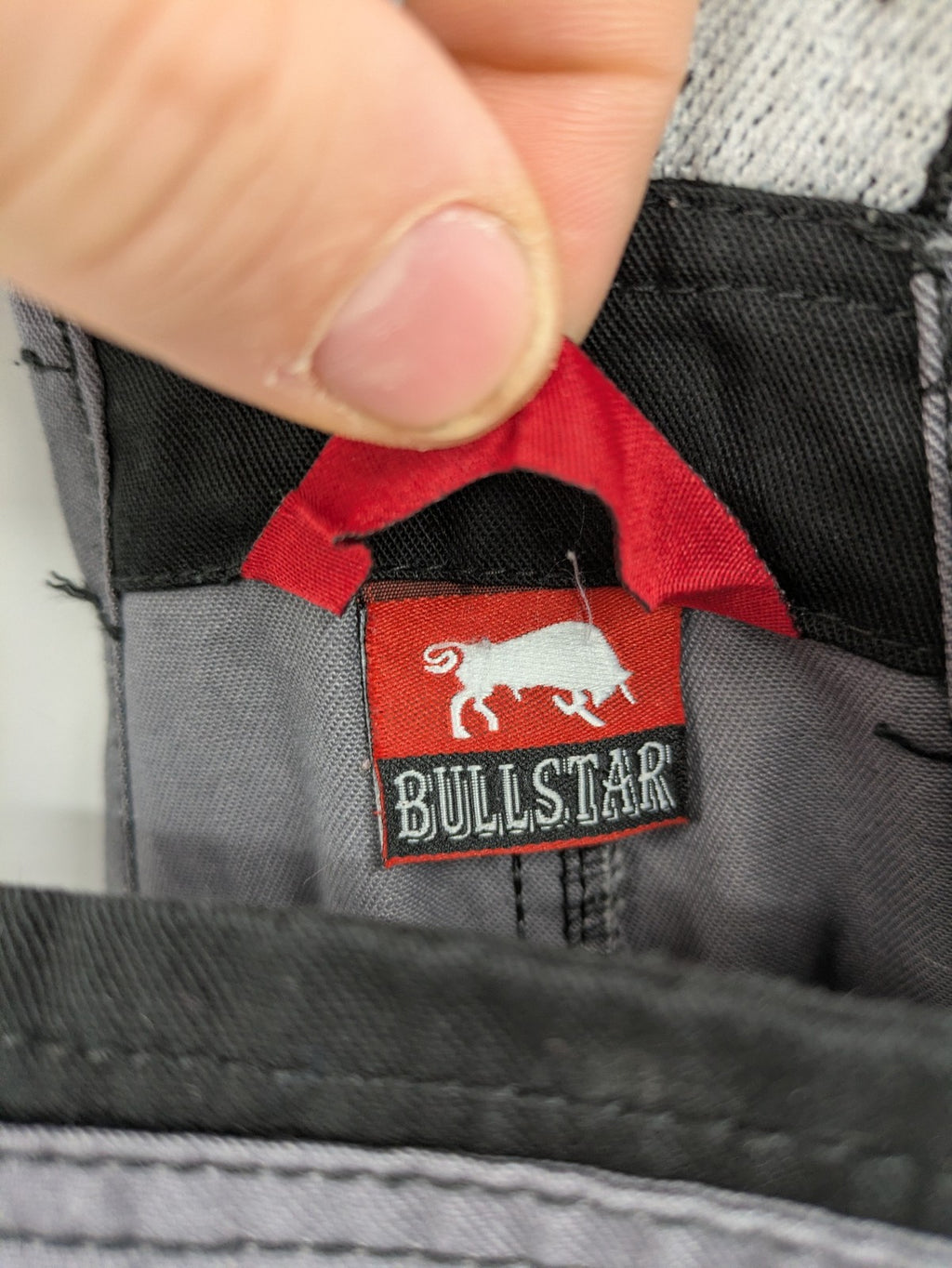 Cargo pants black grey two-tone design with red stitching and multiple pockets