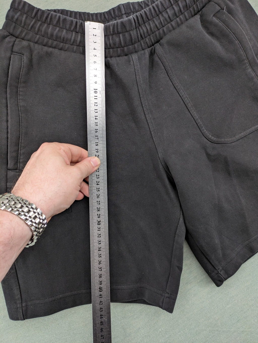 Puma grey sweatshorts featuring Mercedes AMG Petronas logo and elastic waistband.