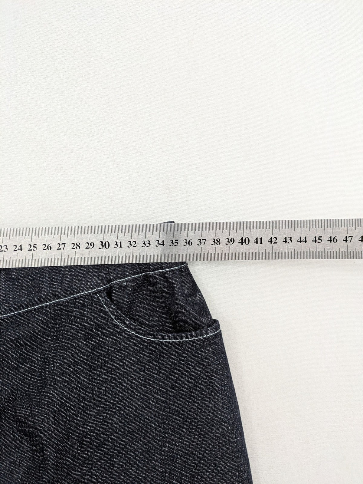 Extyn blue midi skirt with rhinestone dragonfly detail and front slit, stretchy denim fabric.