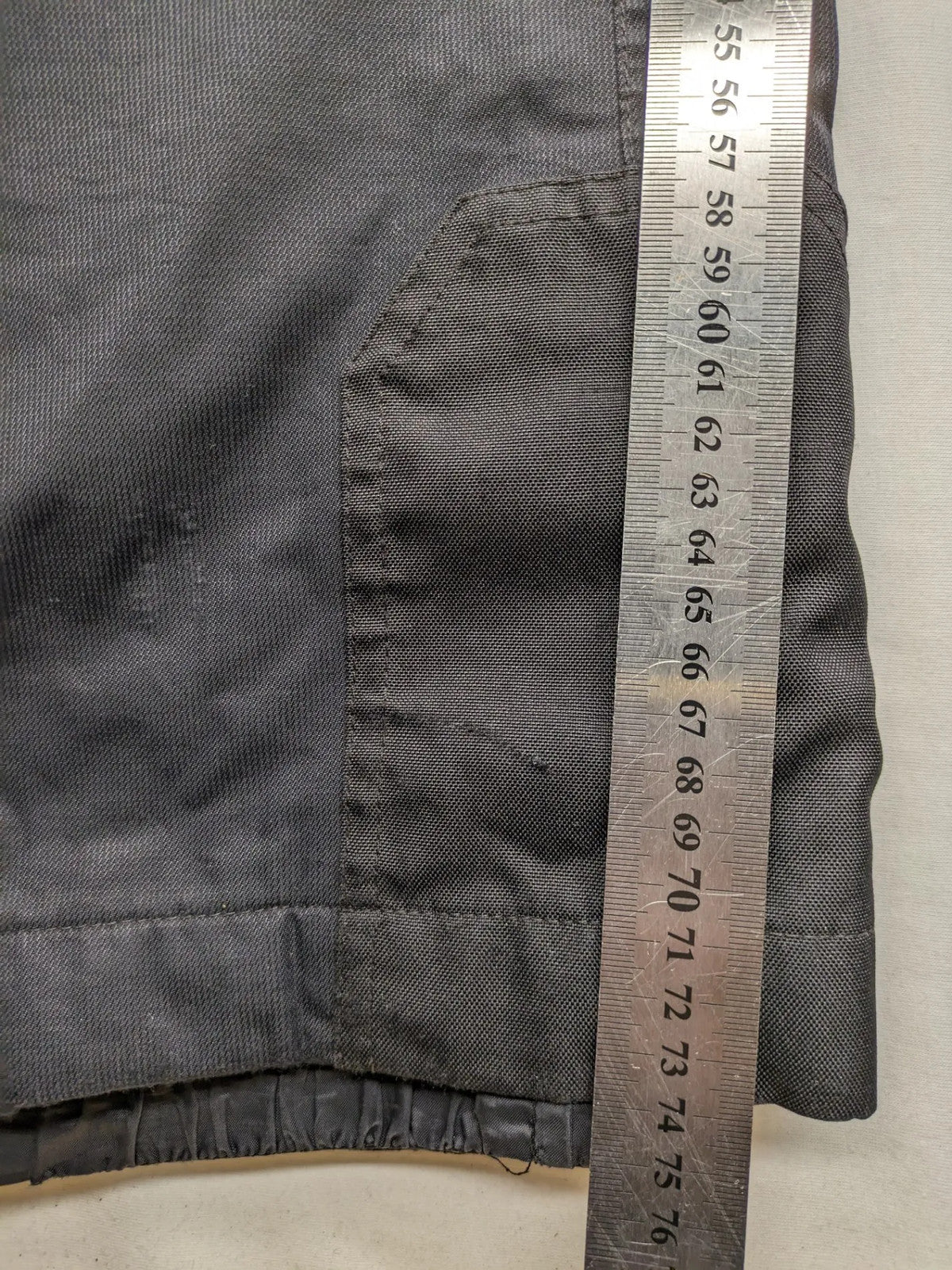 Schoffel black ski pants with adjustable straps, zip pockets, and snow gaiters.