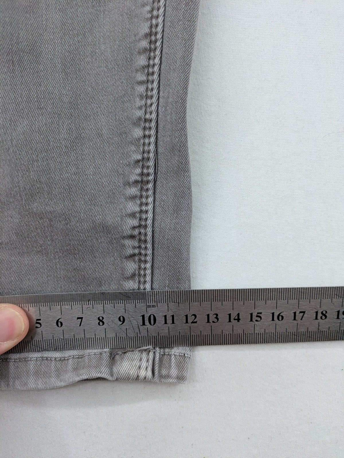 Made in Italy grey biker jeans with zip pockets and structured knee detailing.