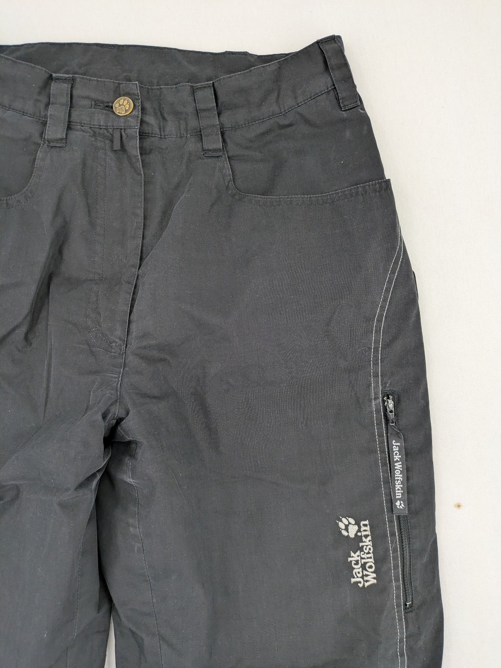 Jack Wolfskin grey outdoor pants with embroidered logo and side zip pocket.