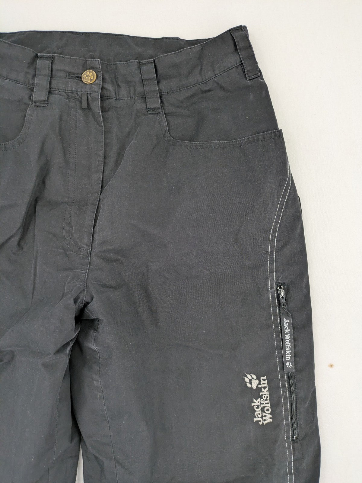 Jack Wolfskin grey outdoor pants with embroidered logo and side zip pocket.
