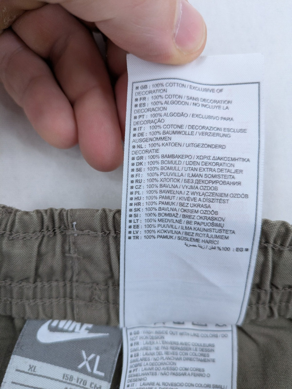 Nike khaki training pants with logo, elastic waistband, and practical pockets.