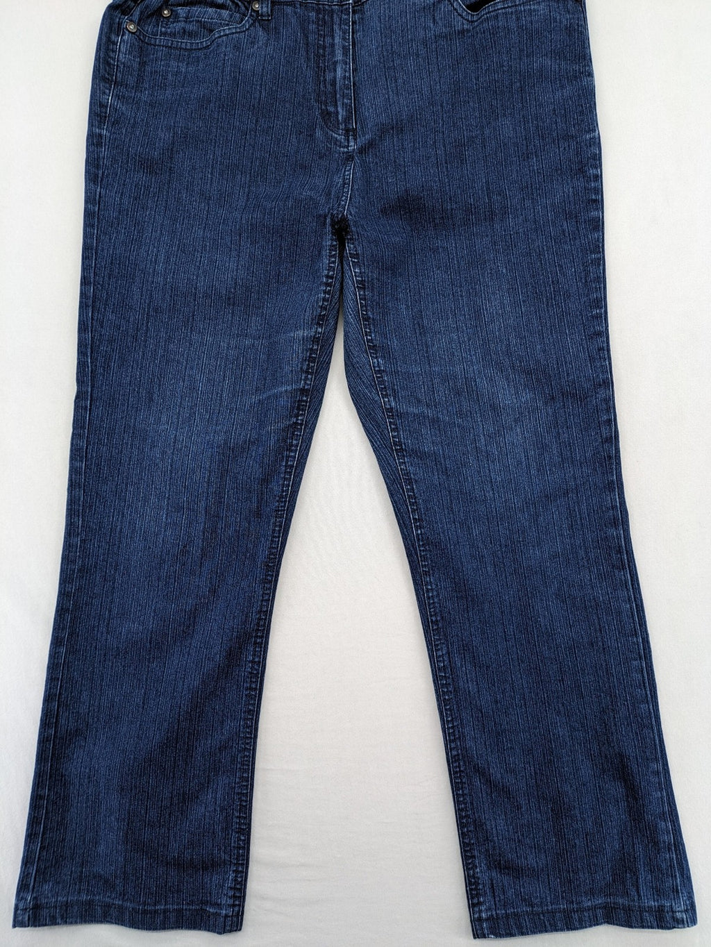 Outfit blue straight jeans with elastic waistband and embroidered crown-wing emblem on pockets.
