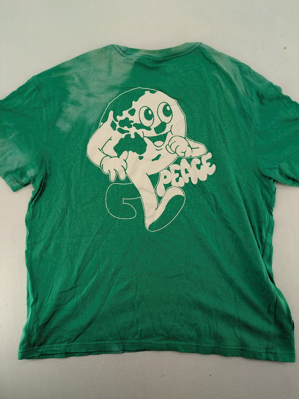 Myla green graphic t-shirt with large peace earth print and front pocket design.