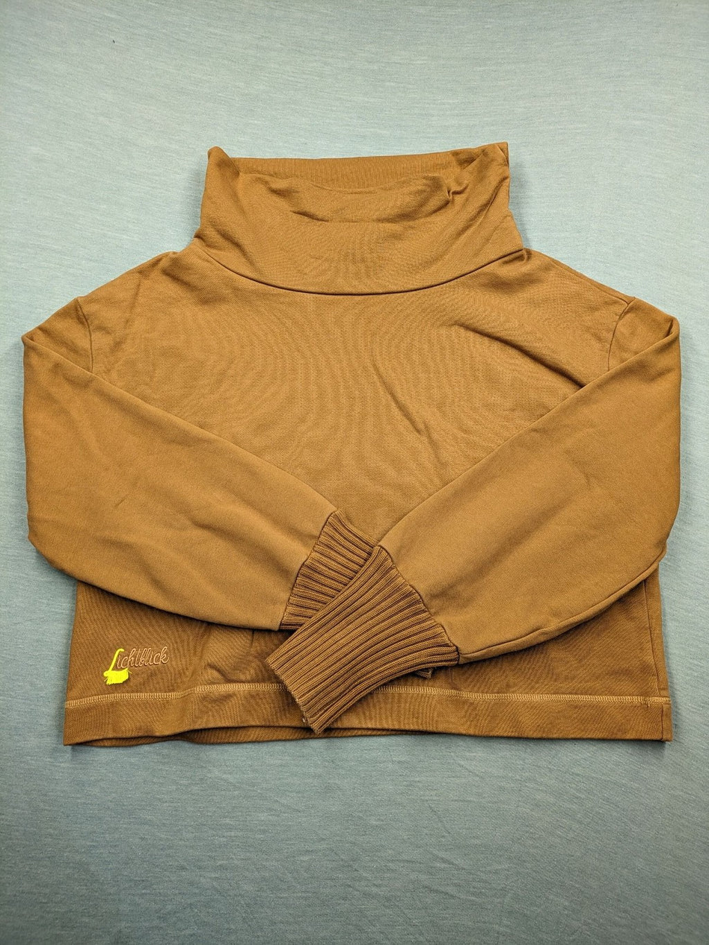 ALS orange crop top sweatshirt with roll neck and embroidered Lichtblick logo.