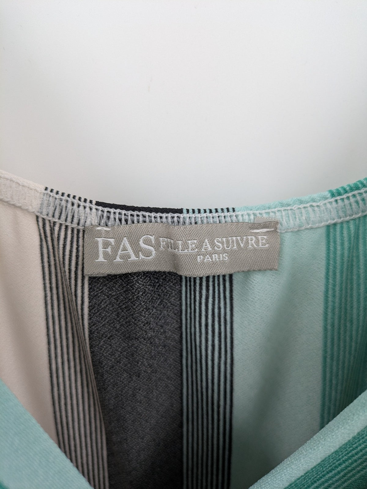 FAS beige and cream striped jumpsuit with deep V-neck and braided spaghetti straps.