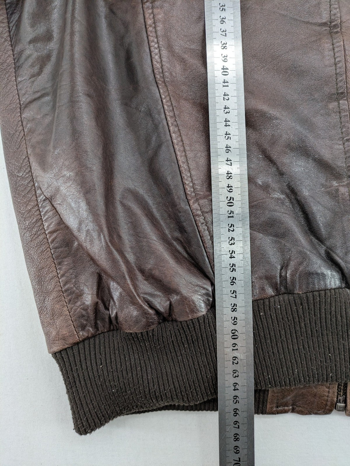 H&M green leather bomber jacket with ribbed collar and moto-style padding.