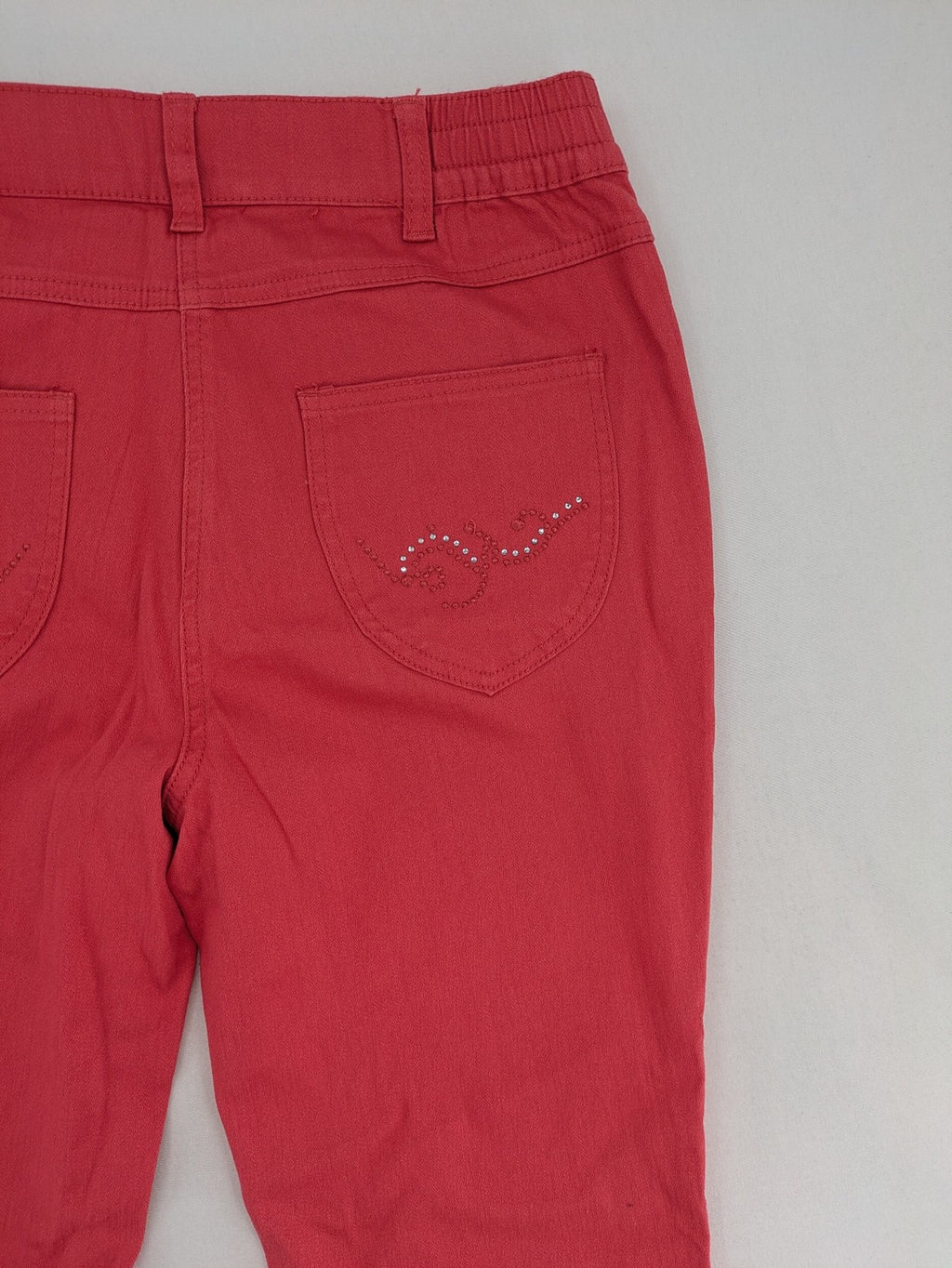 Helena Vera red straight jeans with elastic waistband and rhinestone details on pockets.