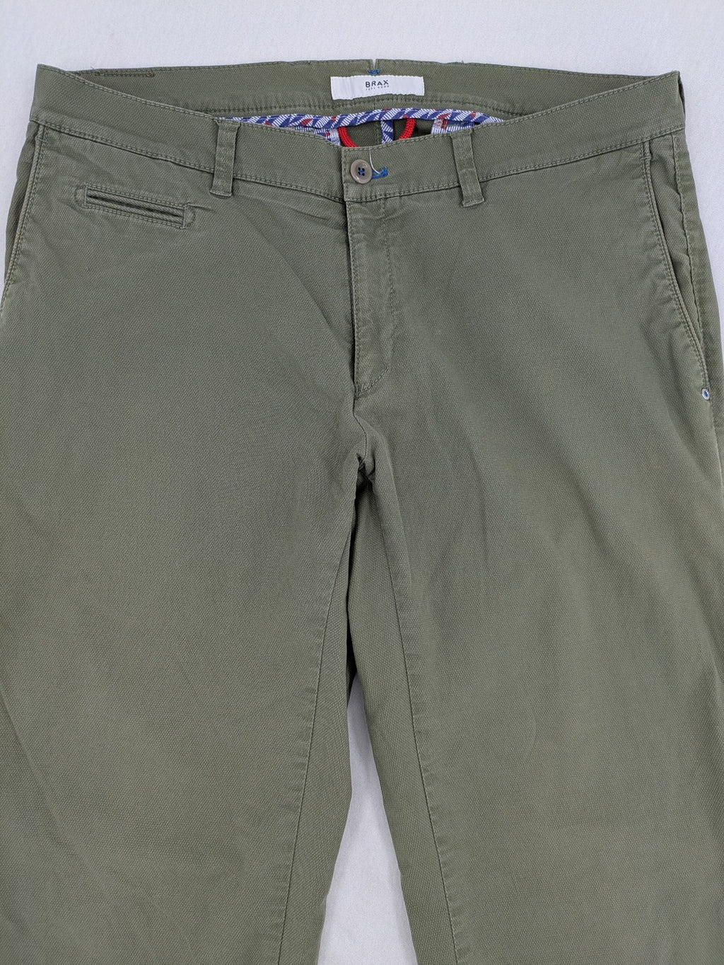 BRAX green chino pants flat-front design with zipper and buttoned back pockets.