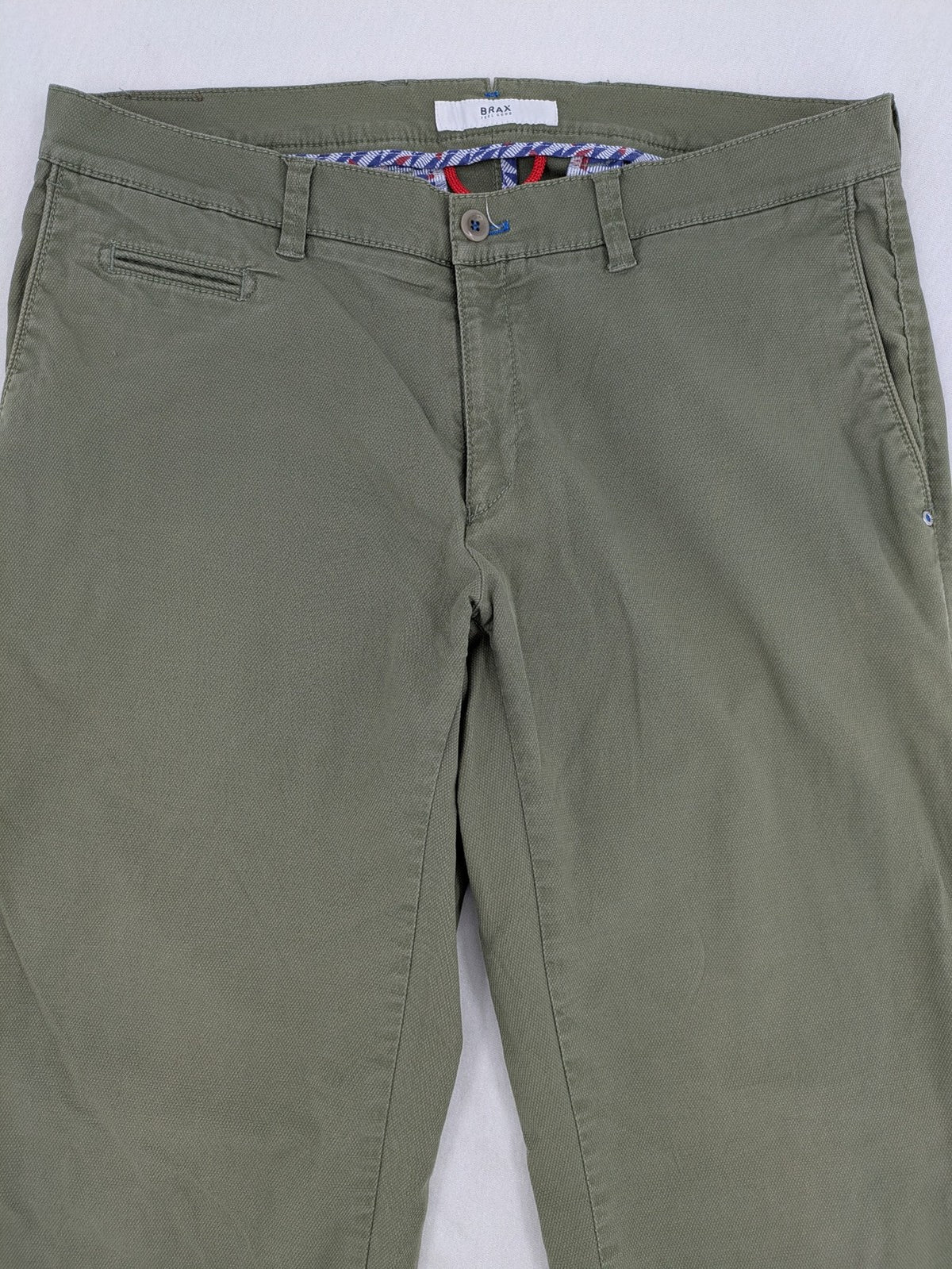 BRAX green chino pants flat-front design with zipper and buttoned back pockets.