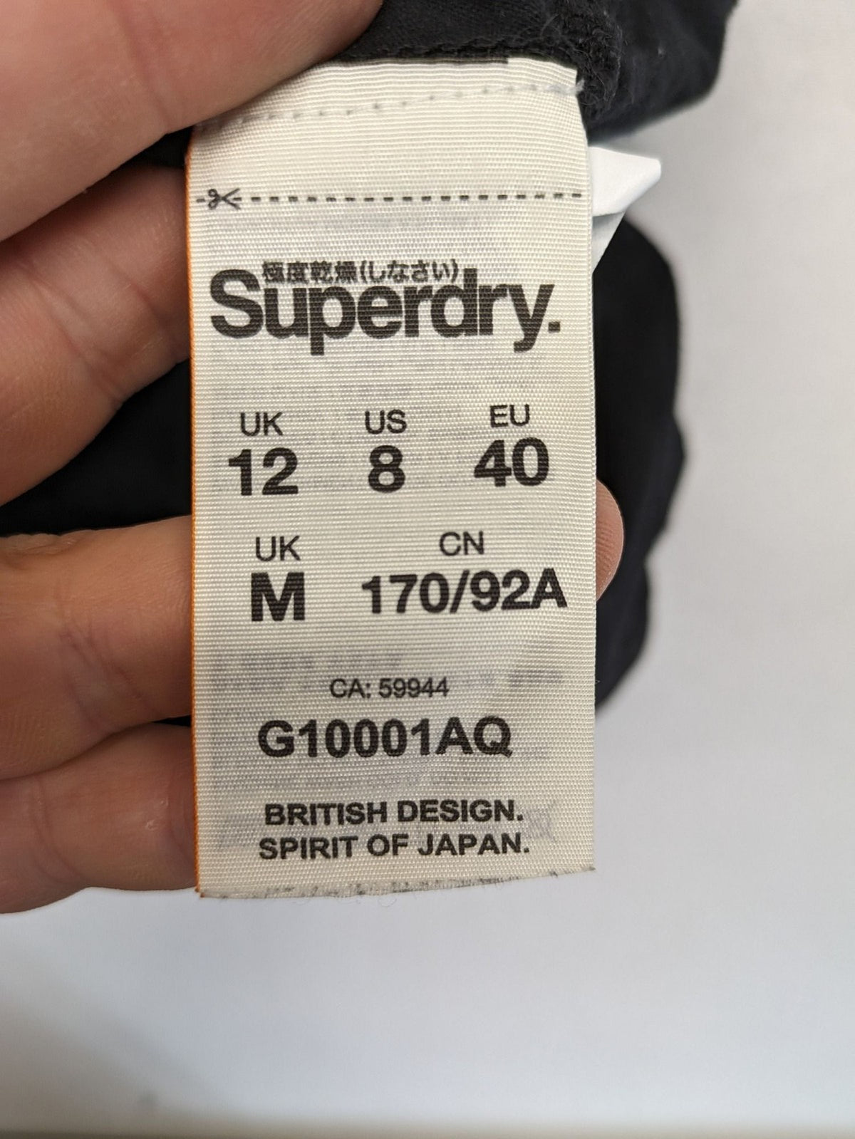 Superdry black t-shirt with large Osaka Brand logo and subtle floral pattern.