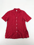 Deerberg red short-sleeve linen blouse with collar, button placket, and side slits.