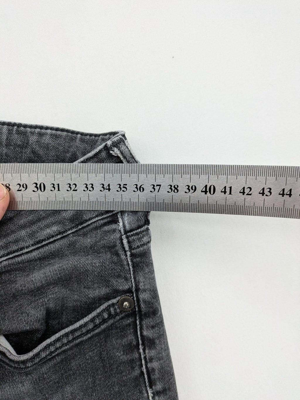 H&M grey skinny jeans with low rise, classic 5-pocket style, and washed denim finish.