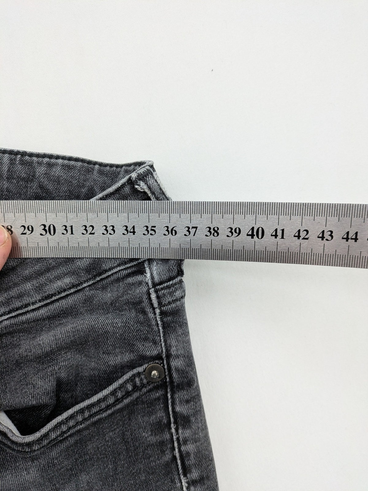 H&M grey skinny jeans with low rise, classic 5-pocket style, and washed denim finish.
