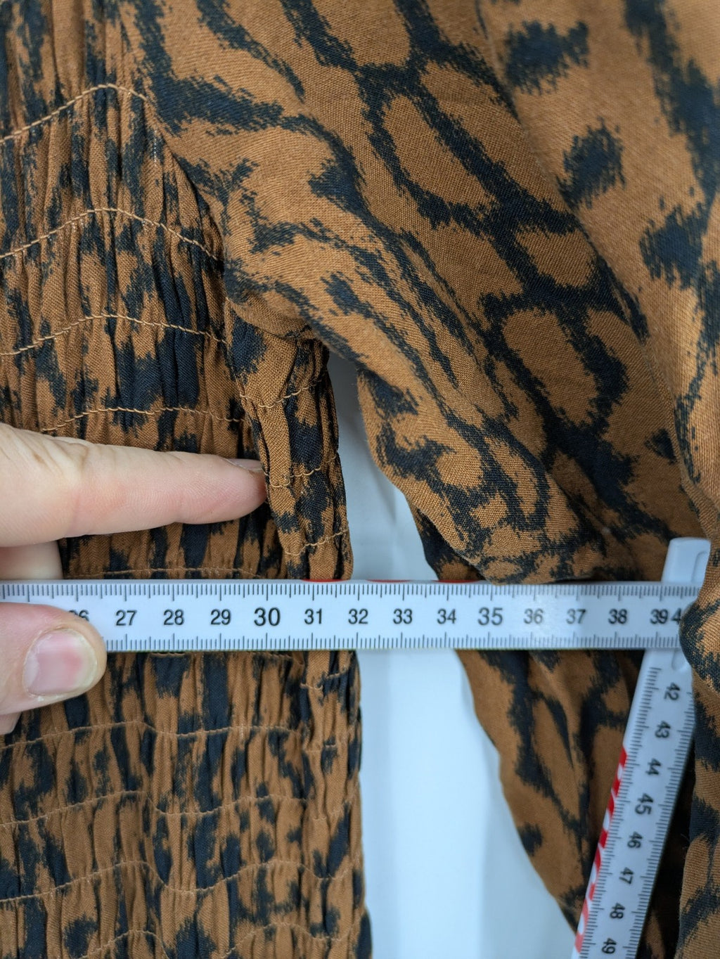 H&M brown and black animal print midi dress with smocked bodice and square neckline.