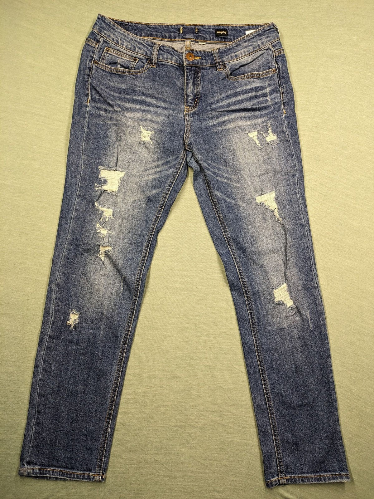 Peg blue ripped straight jeans with distressed details and comfortable stretch material.