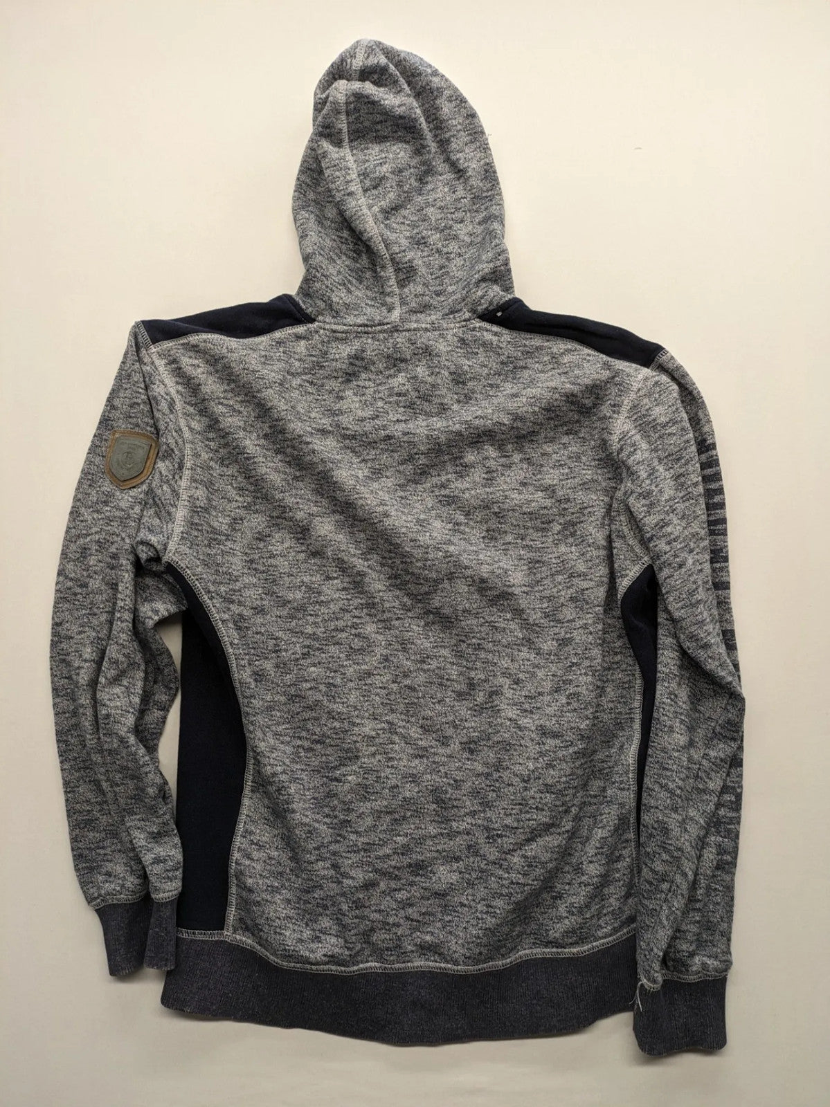 Tom Tompson cream turtle neck jumper with dark blue accents and graphic details on sleeve.